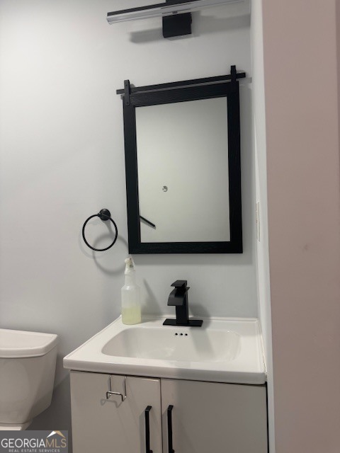 2899 Gresham Rd S East Atlanta, GA 30316 - Photo 14 of 17 a bathroom with a sink a toilet and mirror