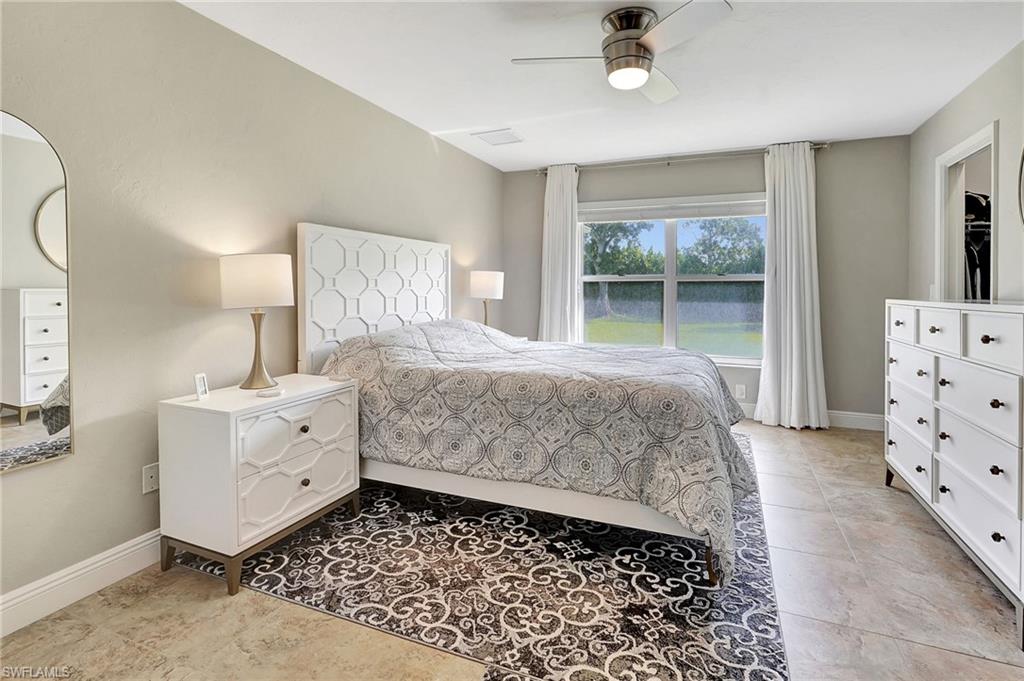 112 Versailles Circle Naples, FL 34112 - Photo 18 of 50 a bedroom with a bed and window
