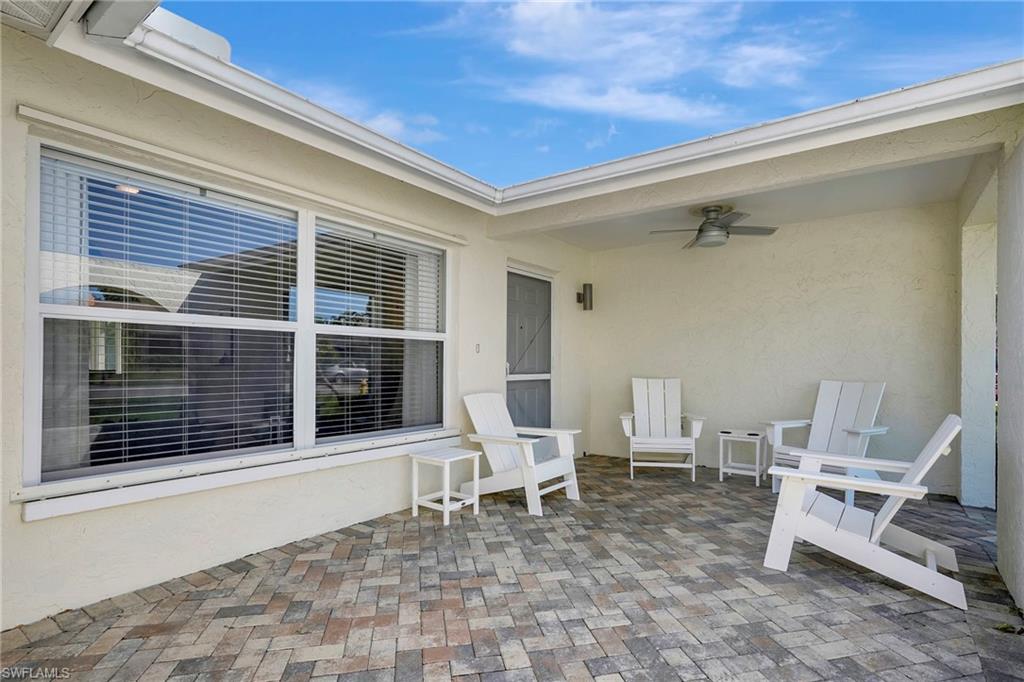112 Versailles Circle Naples, FL 34112 - Photo 2 of 50 a chair and a table in a balcony