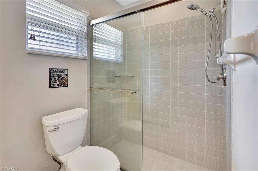 112 Versailles Circle Naples, FL 34112 - Photo 21 of 50 a white toilet sitting next to a bathroom sink