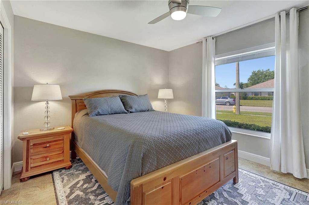 112 Versailles Circle Naples, FL 34112 - Photo 22 of 50 a bedroom with a bed and a window