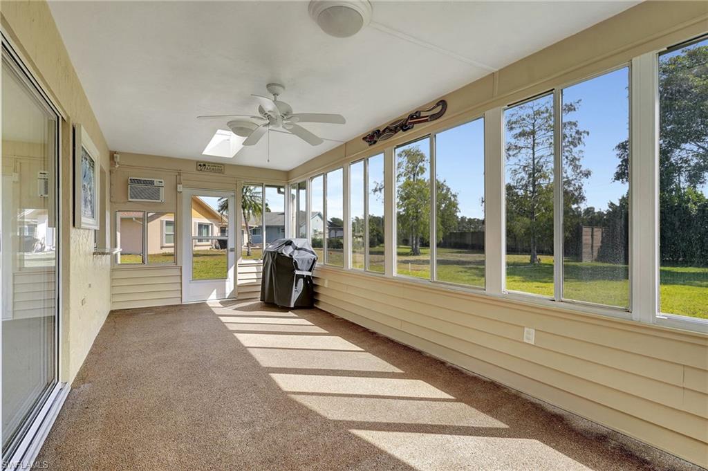 112 Versailles Circle Naples, FL 34112 - Photo 26 of 50 a view of a room with floor to ceiling windows and front door
