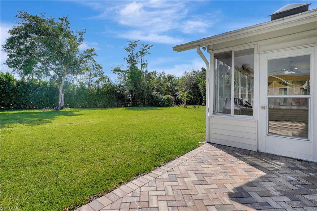 112 Versailles Circle Naples, FL 34112 - Photo 29 of 50 a view of a backyard with large trees and plants