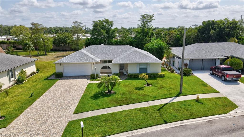 112 Versailles Circle Naples, FL 34112 - Photo 30 of 50 a front view of a house with a yard