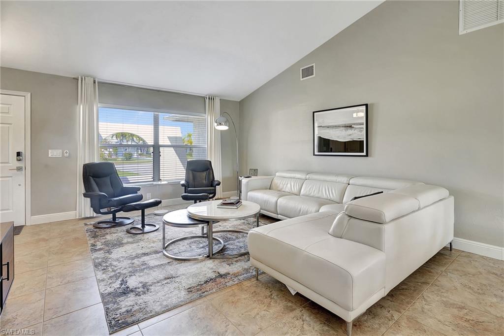 112 Versailles Circle Naples, FL 34112 - Photo 4 of 50 a living room with furniture and a large window