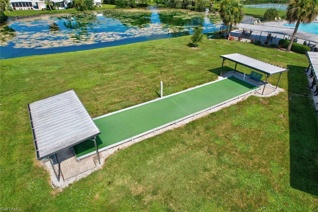 112 Versailles Circle Naples, FL 34112 - Photo 49 of 50 an aerial view of a pool with a garden and lake view