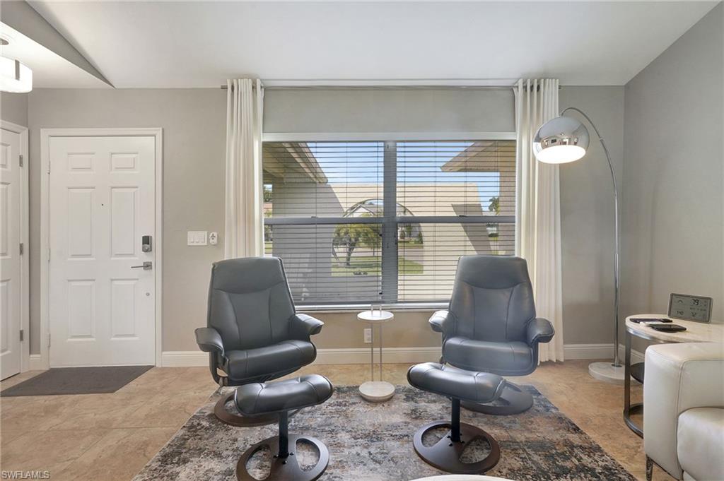 112 Versailles Circle Naples, FL 34112 - Photo 5 of 50 a living room with furniture and a large window