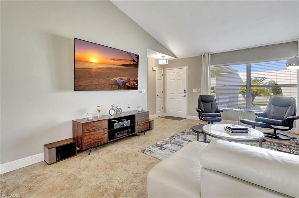 112 Versailles Circle Naples, FL 34112 - Photo 6 of 50 a living room with furniture and a flat screen tv
