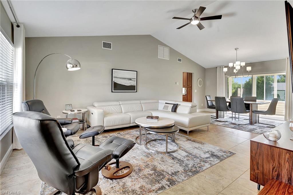 112 Versailles Circle Naples, FL 34112 - Photo 7 of 50 a living room with furniture and a chandelier