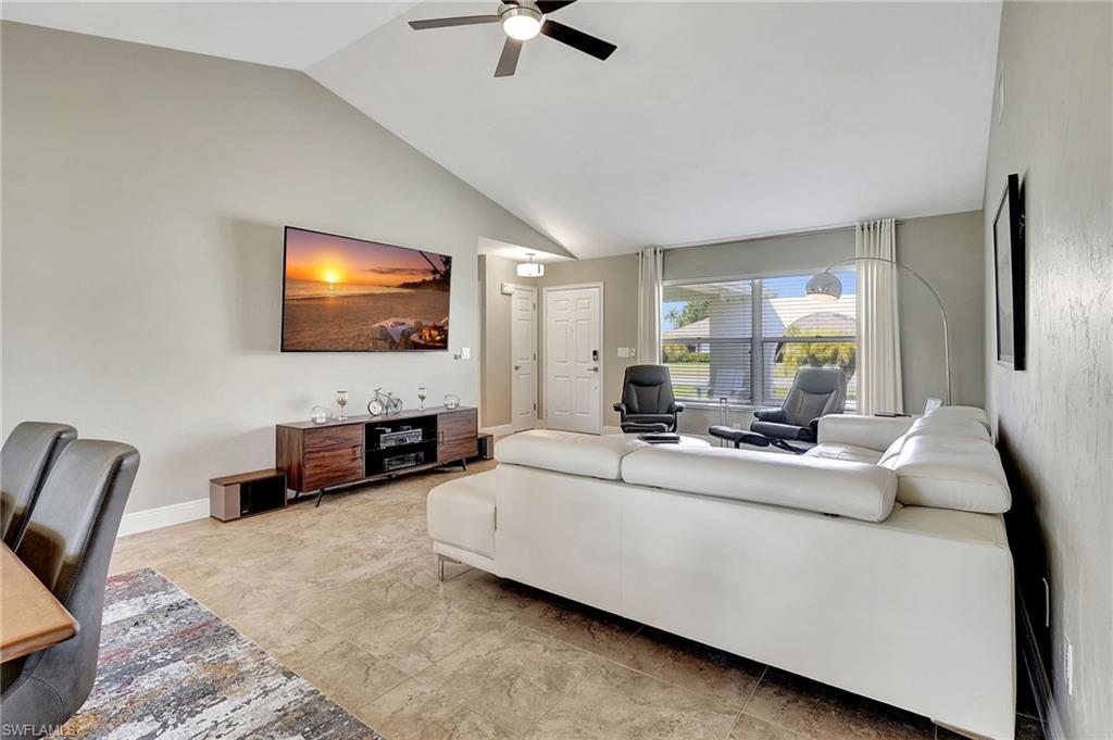 112 Versailles Circle Naples, FL 34112 - Photo 8 of 50 a living room with furniture and a flat screen tv