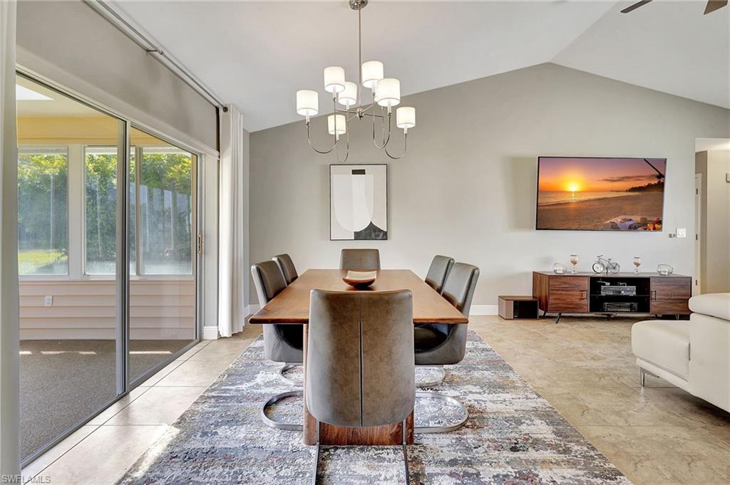 112 Versailles Circle Naples, FL 34112 - Photo 9 of 50 a living room with fireplace furniture and a flat screen tv