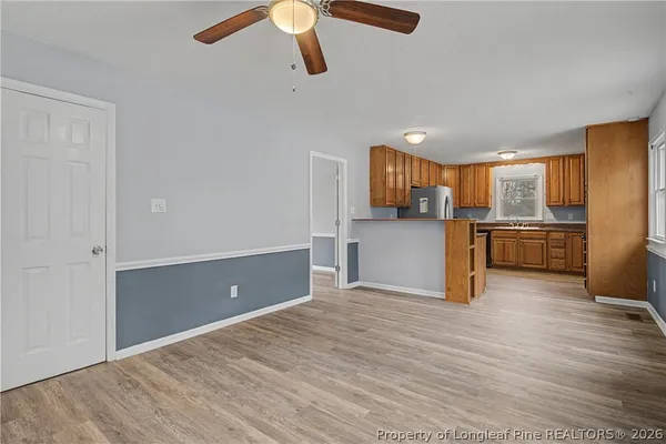 a kitchen with stainless steel appliances a refrigerator and a stove top oven