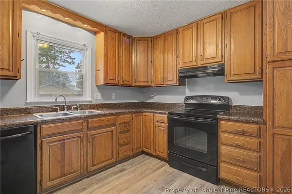 a kitchen with stainless steel appliances granite countertop a refrigerator and a stove