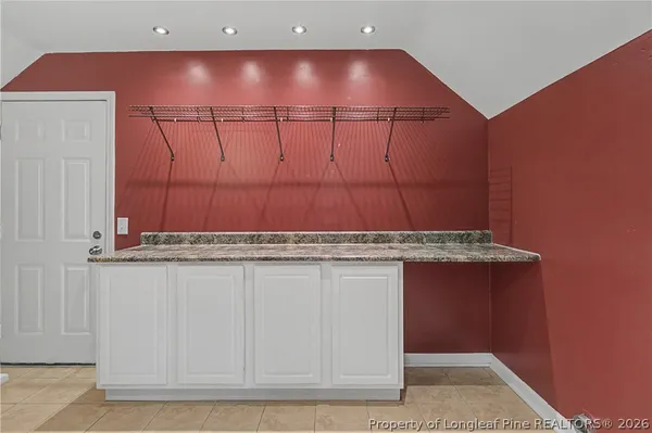 a bathroom with a granite countertop sink a toilet and mirror