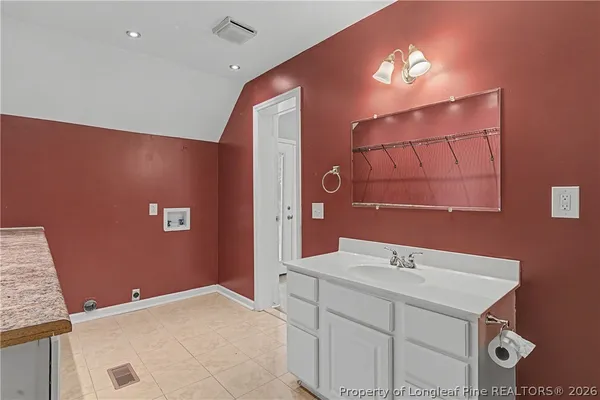 a bedroom with a large bed and a rug