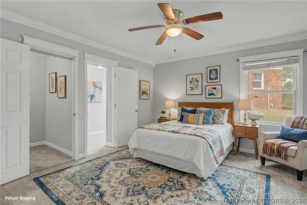 a view of an empty room and chandelier fan