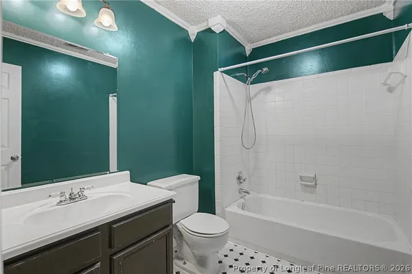a bathroom with a sink a toilet a mirror and shower