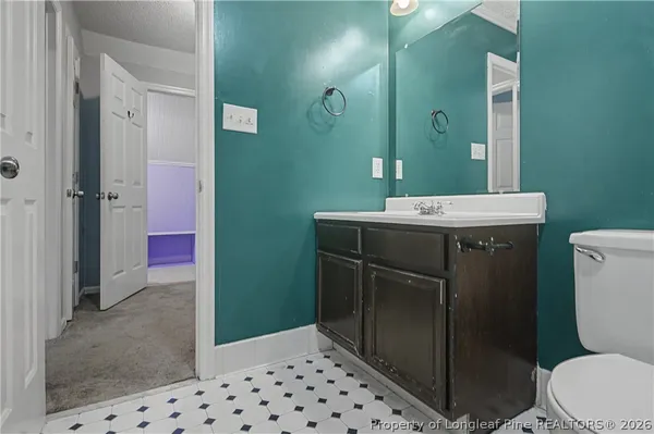 a spacious bedroom with a bed and a chandelier