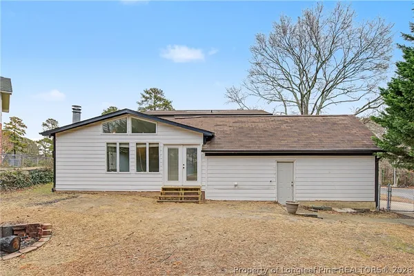 a house that has a tree in front of it