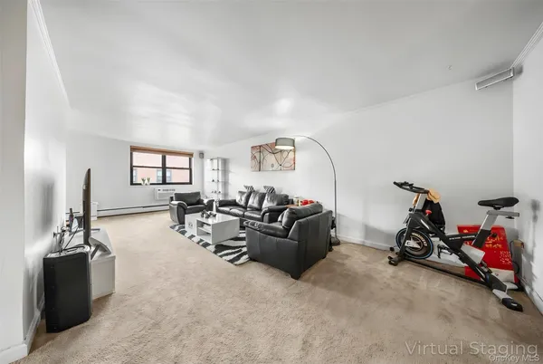 a living room with furniture and a gym machine
