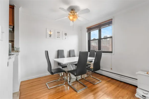 a view of a dining room with furniture a chandelier and wooden floor