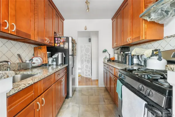 a kitchen with stainless steel appliances granite countertop a stove and a sink