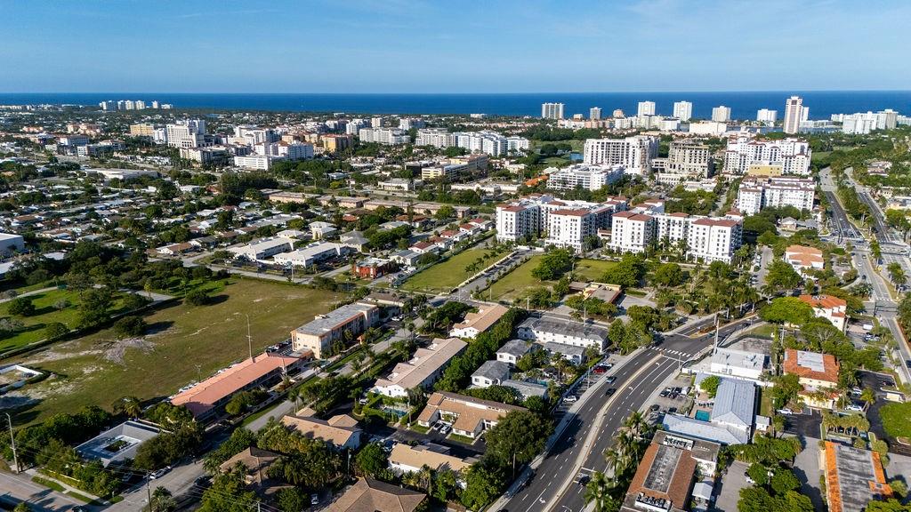 331 Southwest 8th Street, Unit 1CE Boca Raton, FL 33432 - Photo 4 of 4 an aerial view of a city with lots of residential buildings ocean and mountain view in back