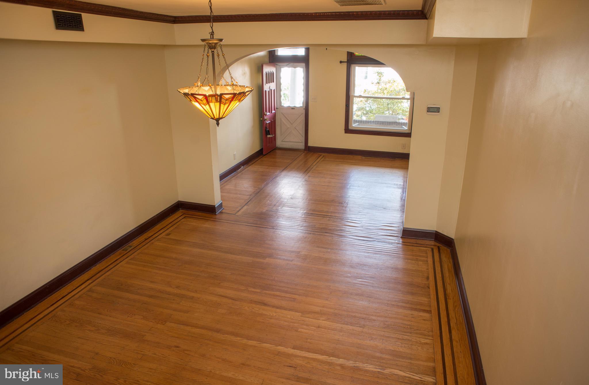 3652 Keswick Road Baltimore, MD 21211 - Photo 4 of 16 a view of hallway with stairs and wooden floor