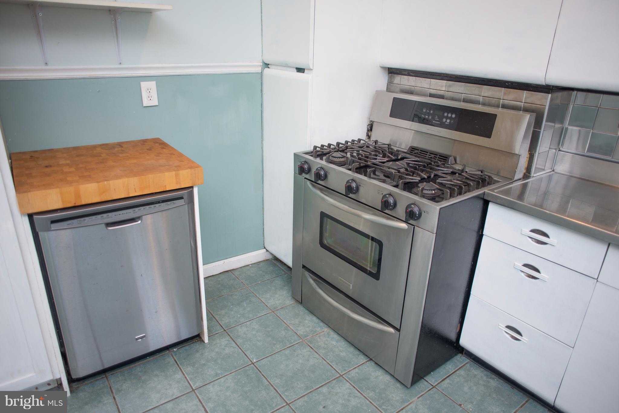 3652 Keswick Road Baltimore, MD 21211 - Photo 6 of 16 a kitchen with granite countertop cabinets and white stove