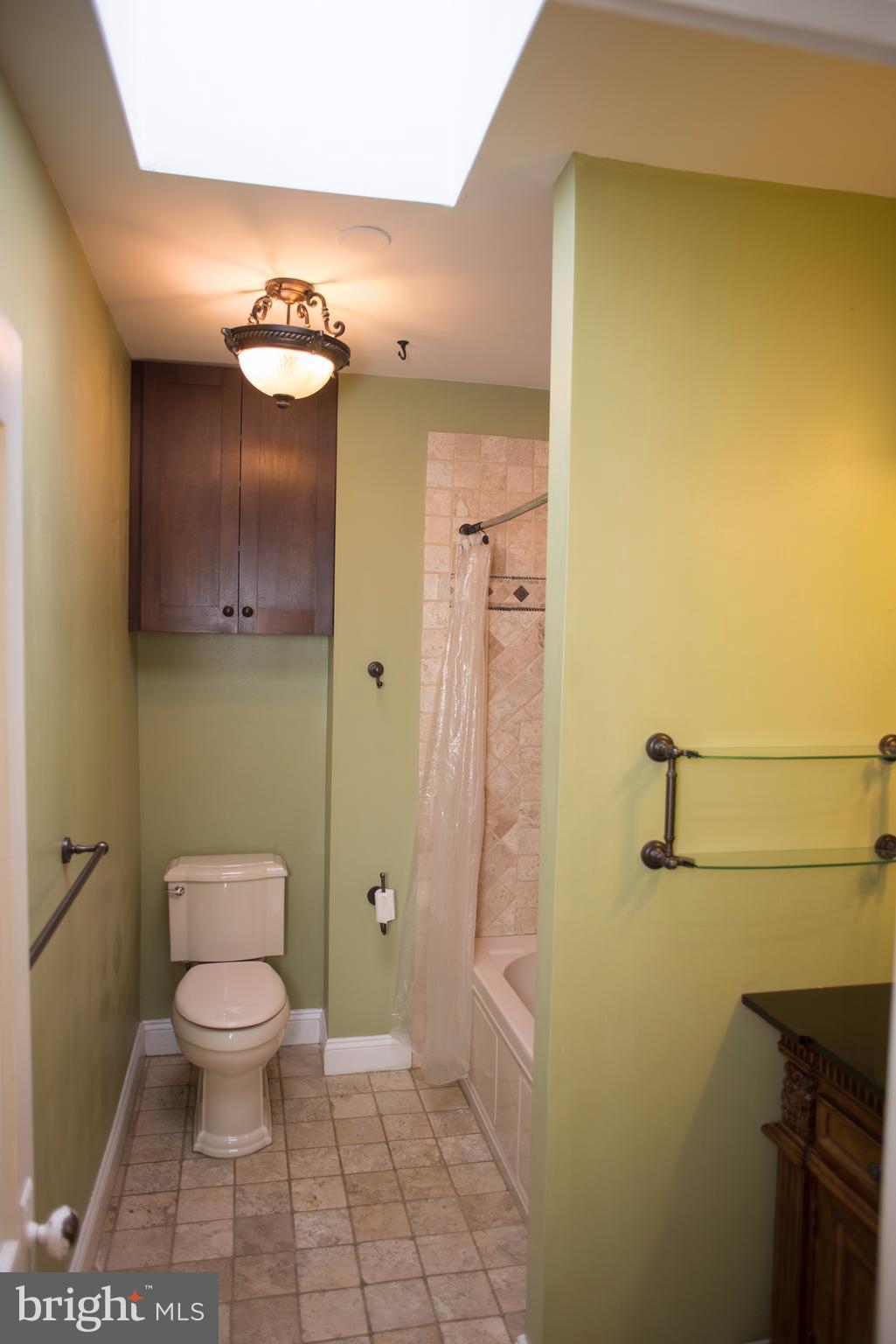 3652 Keswick Road Baltimore, MD 21211 - Photo 8 of 16 a bathroom with a toilet and a shower