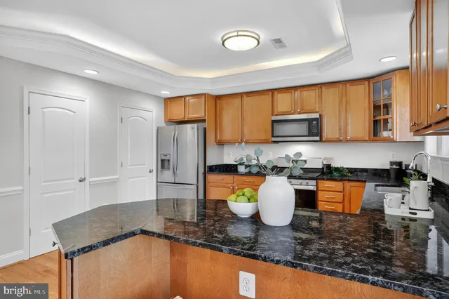 a kitchen with granite countertop a stove a sink and a granite counter tops