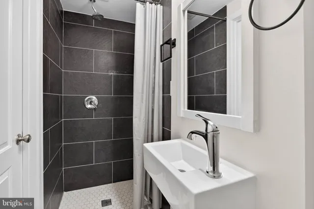 a bathroom with a sink a toilet and a mirror