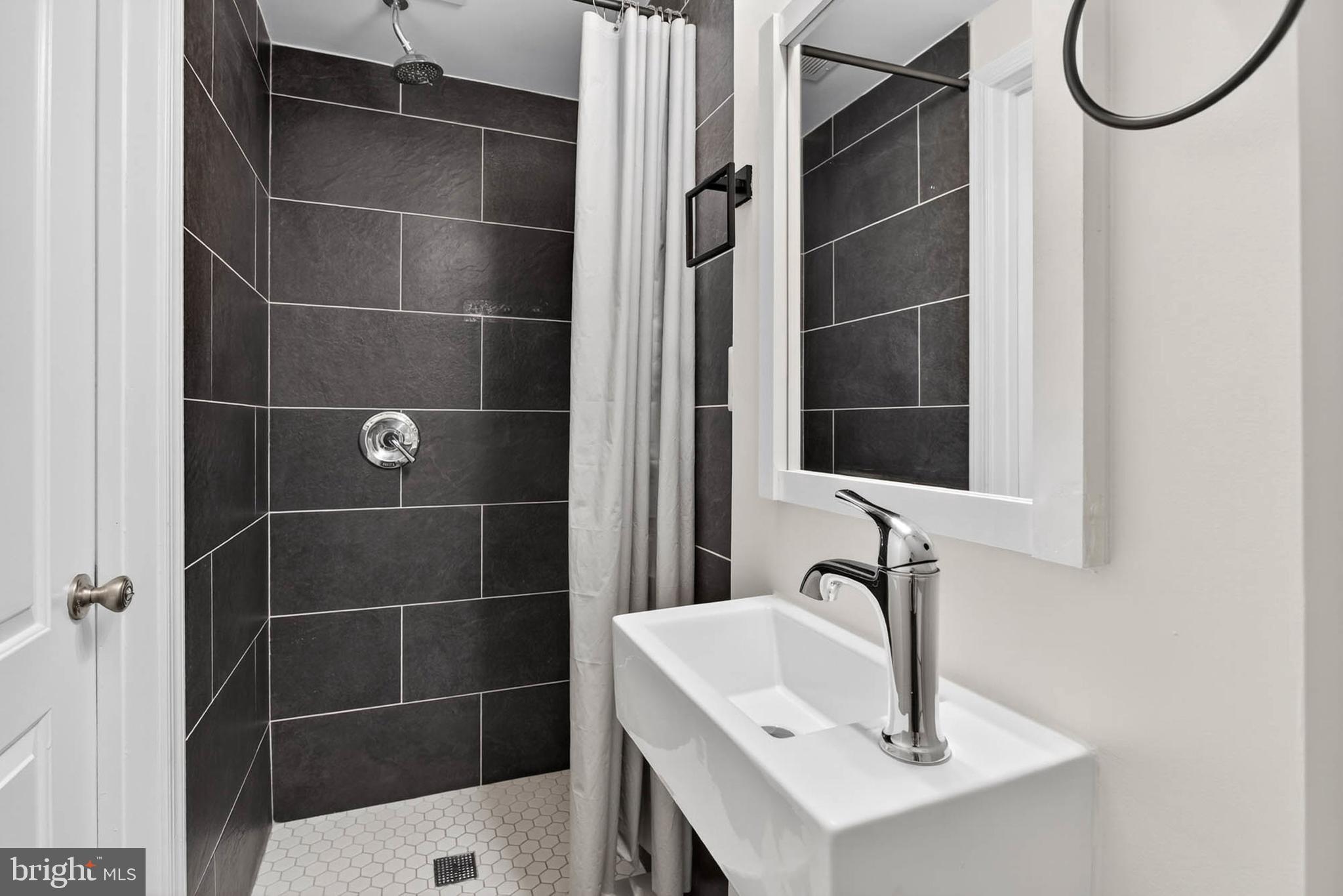 1125 Race Street Baltimore, MD 21230 - Photo 27 of 43 a bathroom with a sink a toilet and a mirror