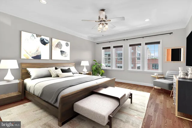 a spacious bedroom with a large bed and a chandelier