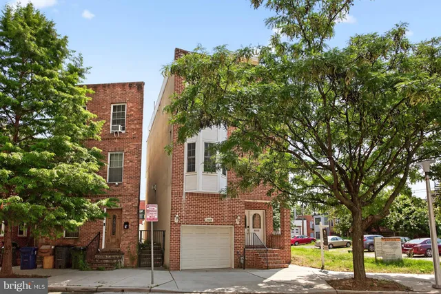 front view of a building with a tree