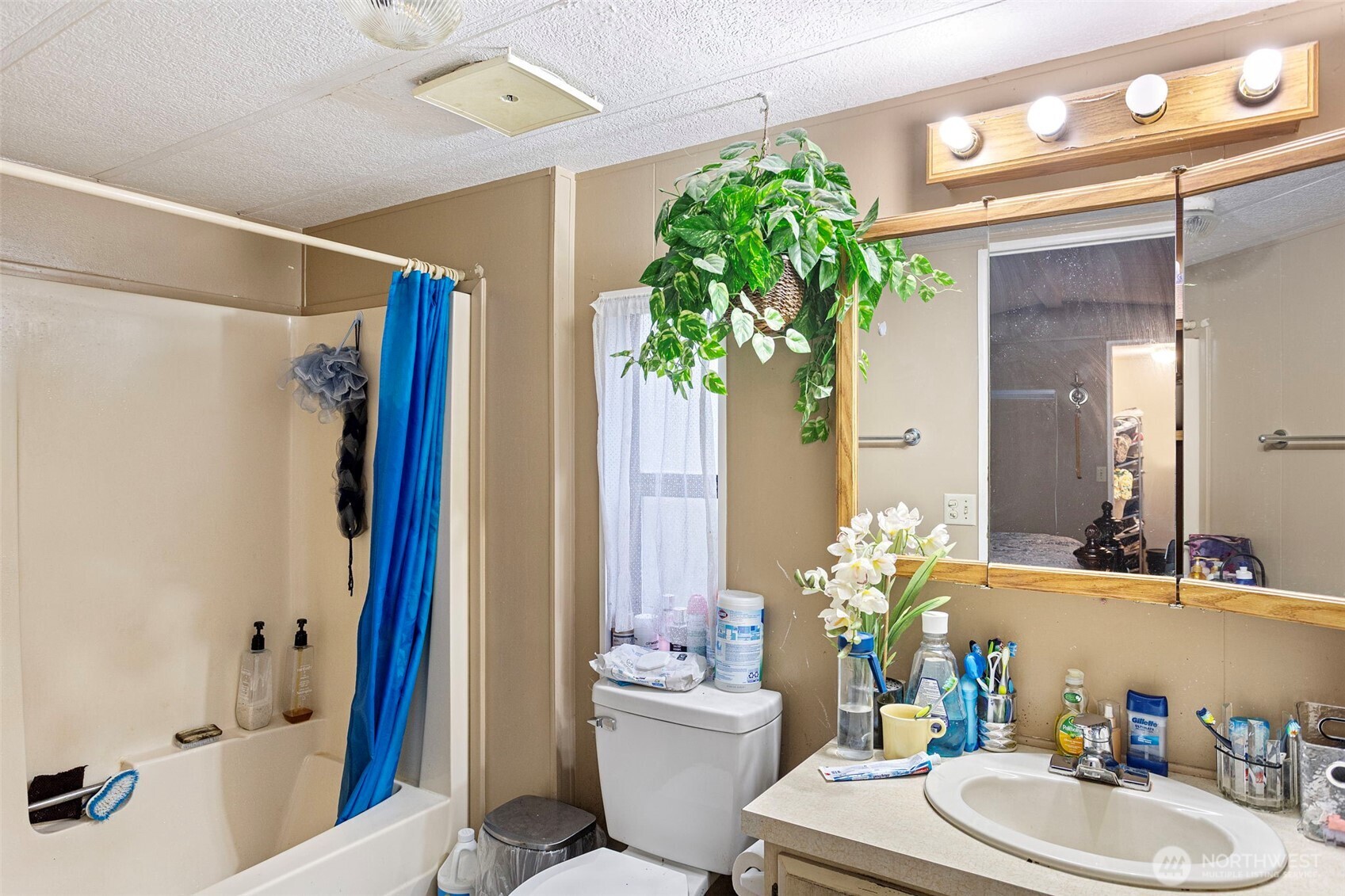 375 Union Avenue Southeast, Unit 46 Renton, WA 98059 - Photo 12 of 17 a bathroom with a granite countertop sink and a mirror