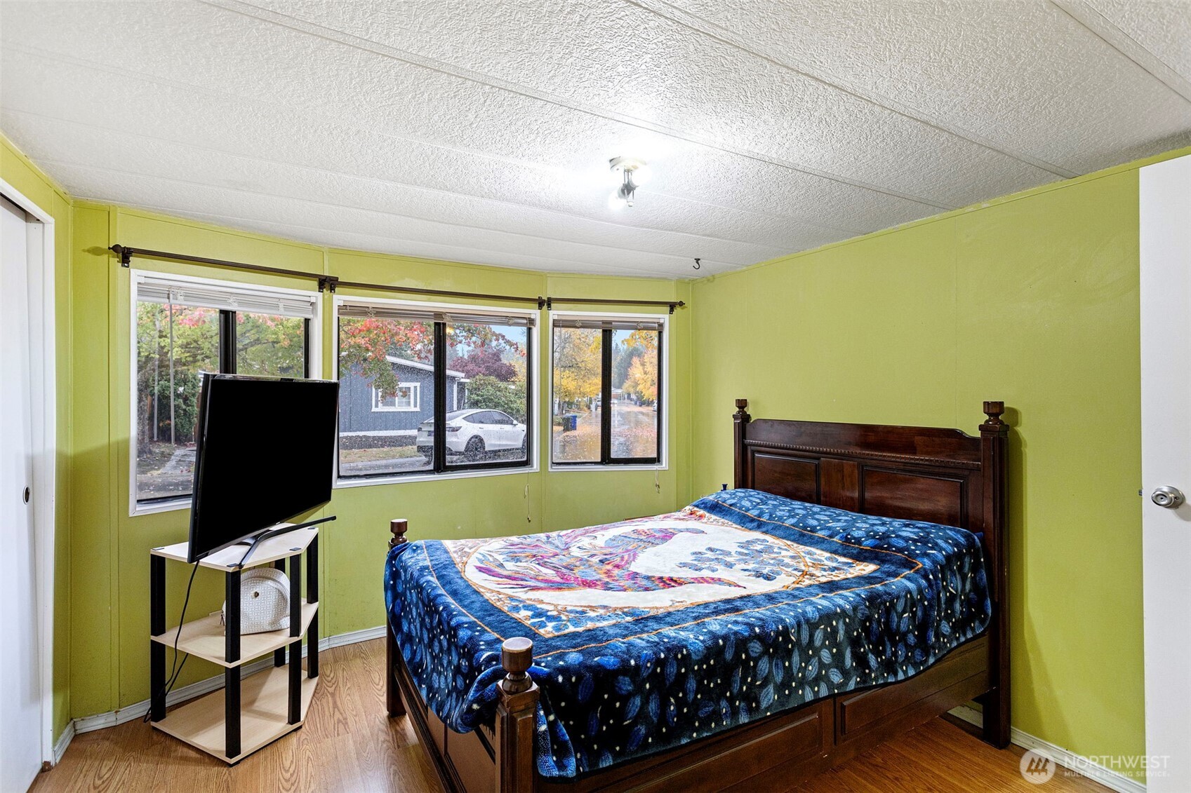 375 Union Avenue Southeast, Unit 46 Renton, WA 98059 - Photo 14 of 17 a bedroom with a bed flat screen tv and a large window