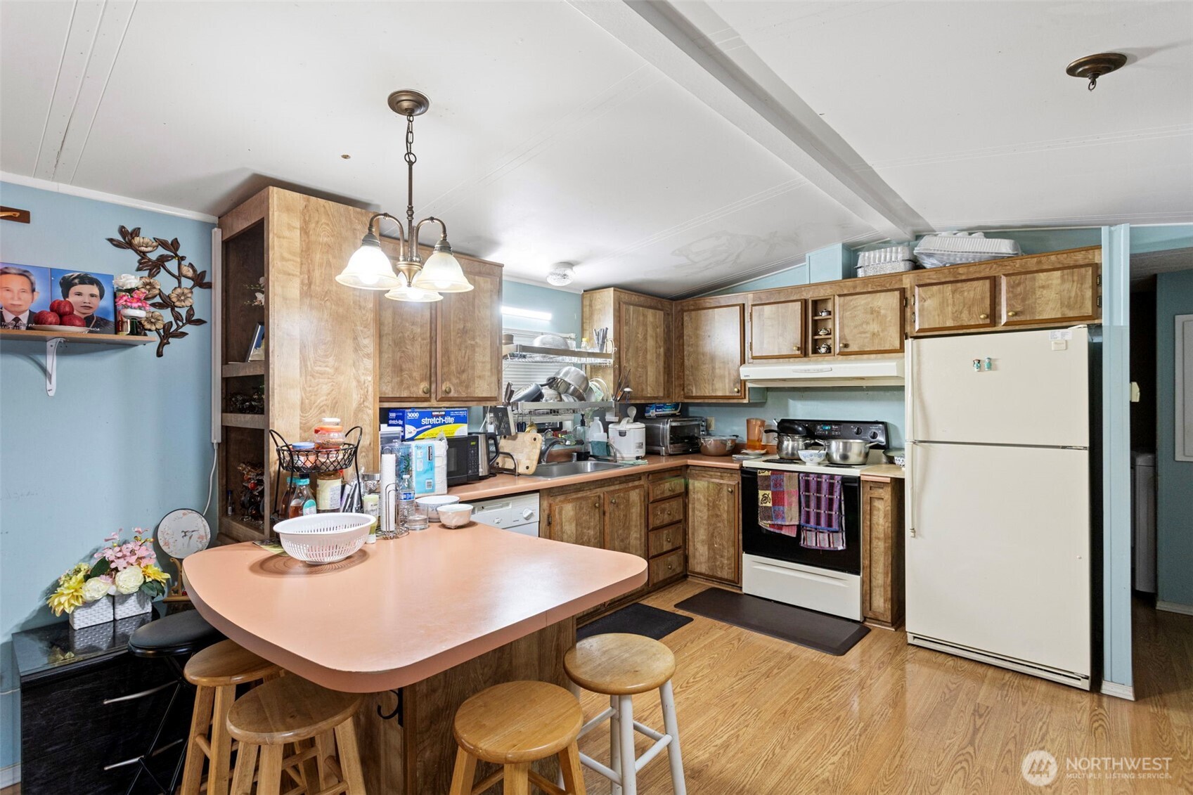 375 Union Avenue Southeast, Unit 46 Renton, WA 98059 - Photo 7 of 17 a kitchen with stainless steel appliances granite countertop a sink a stove a refrigerator a dining table and chairs