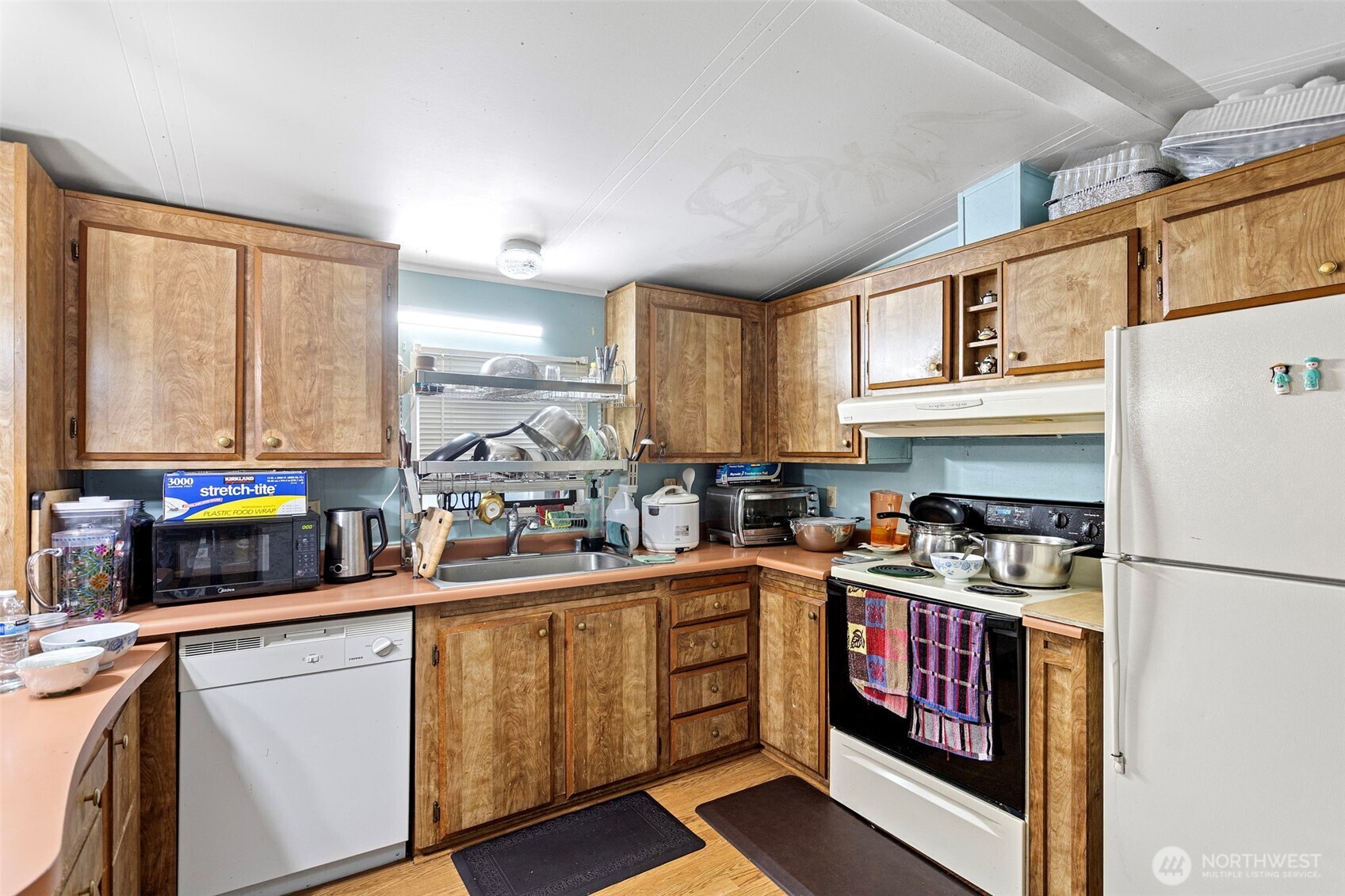 375 Union Avenue Southeast, Unit 46 Renton, WA 98059 - Photo 8 of 17 a kitchen with stainless steel appliances a sink a stove a refrigerator cabinets and a window