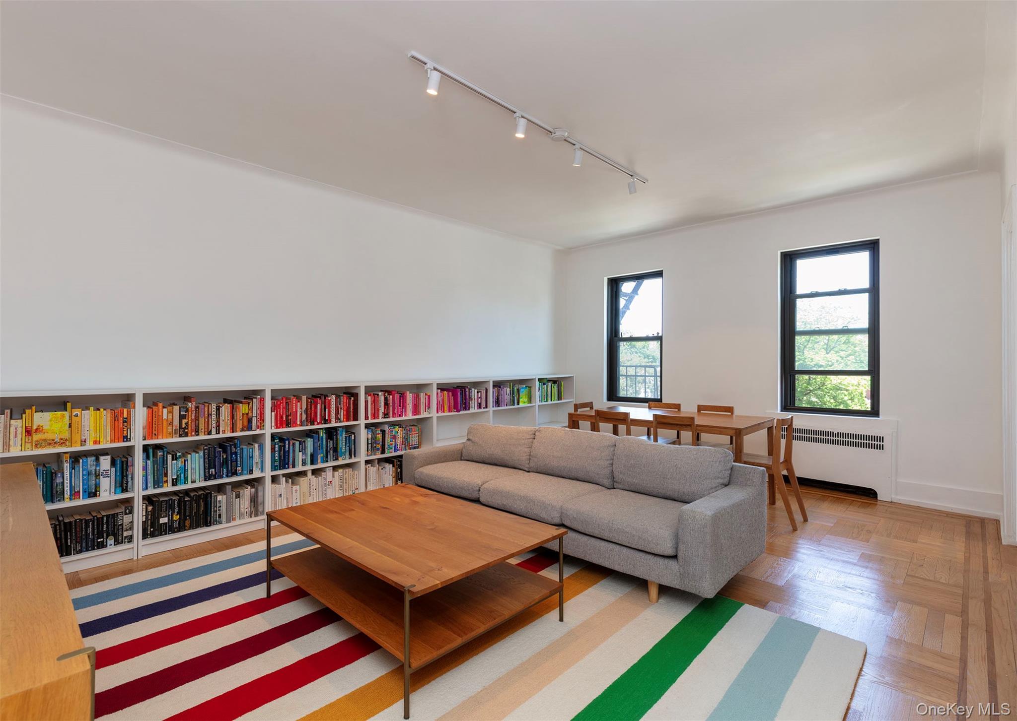 a living room with furniture and a book shelf