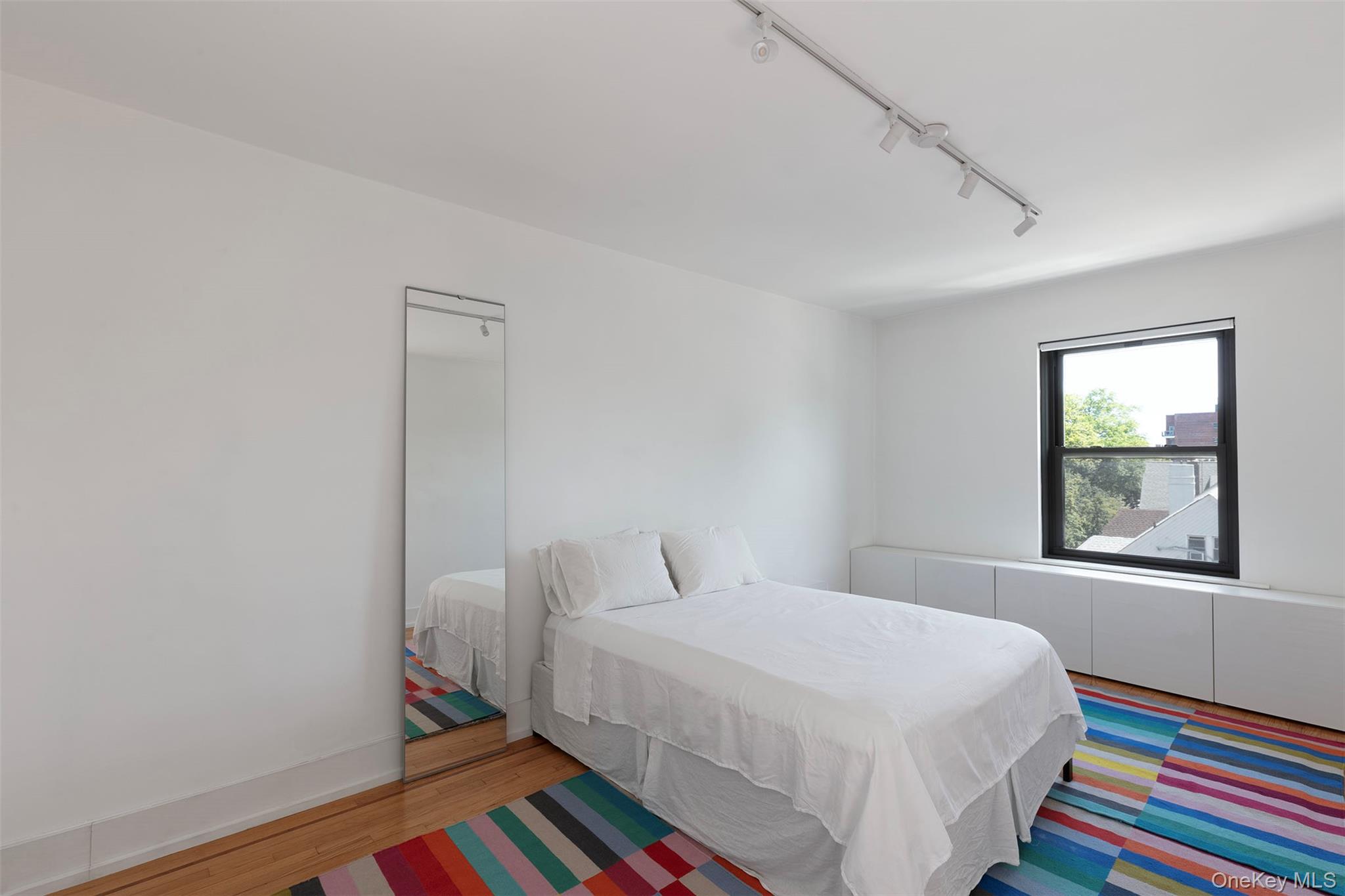 76-66 Austin Street, Unit 3L Queens, NY 11375 - Photo 20 of 28 a bedroom with a bed and a window