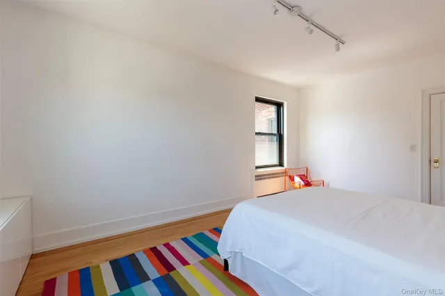 a bedroom with a bed and a lamp