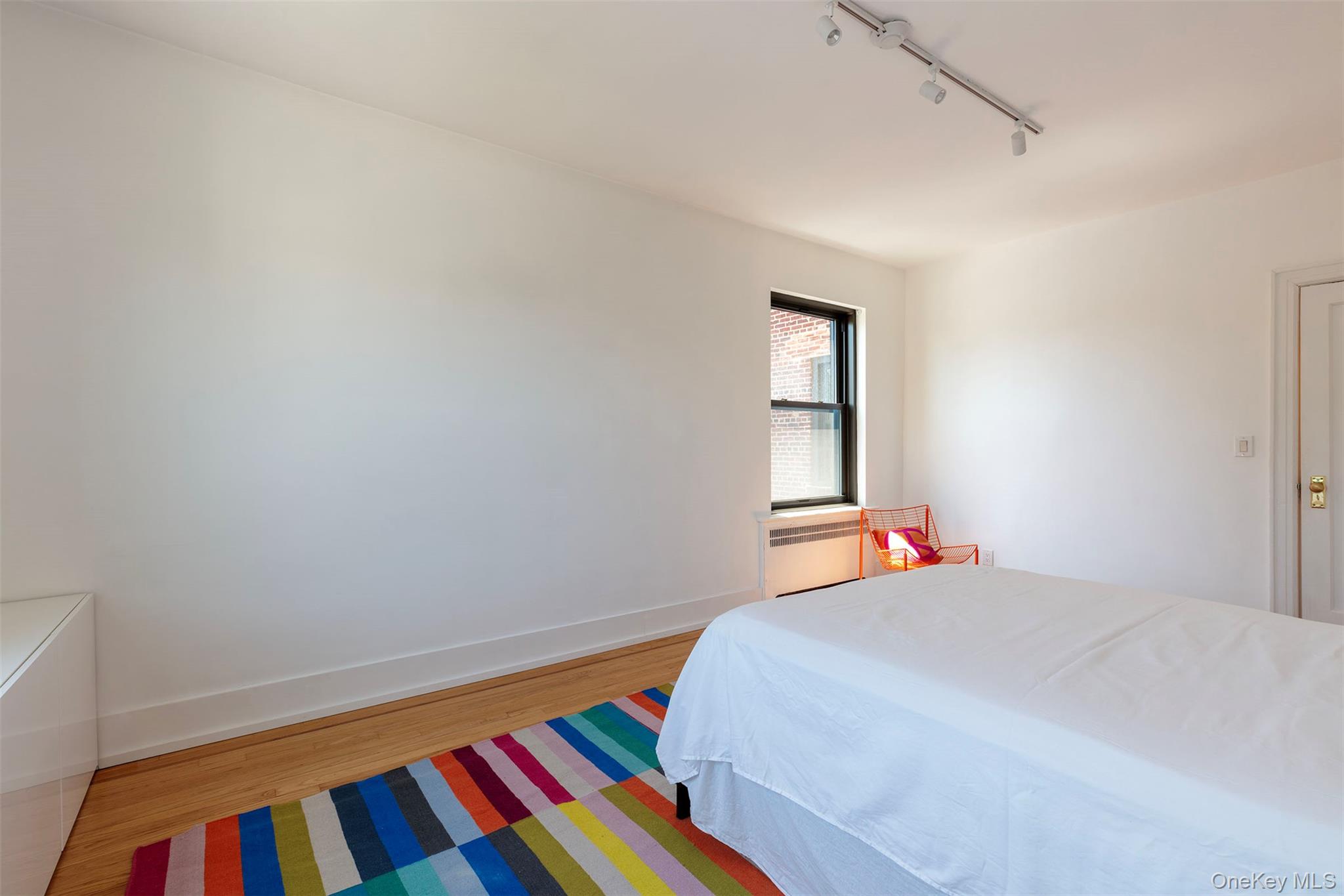 76-66 Austin Street, Unit 3L Queens, NY 11375 - Photo 21 of 28 a bedroom with a bed and a lamp