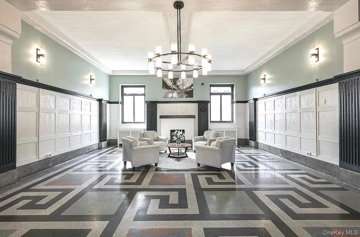 76-66 Austin Street, Unit 3L Queens, NY 11375 - Photo 27 of 28 a view of a dining room with furniture a chandelier and wooden floor