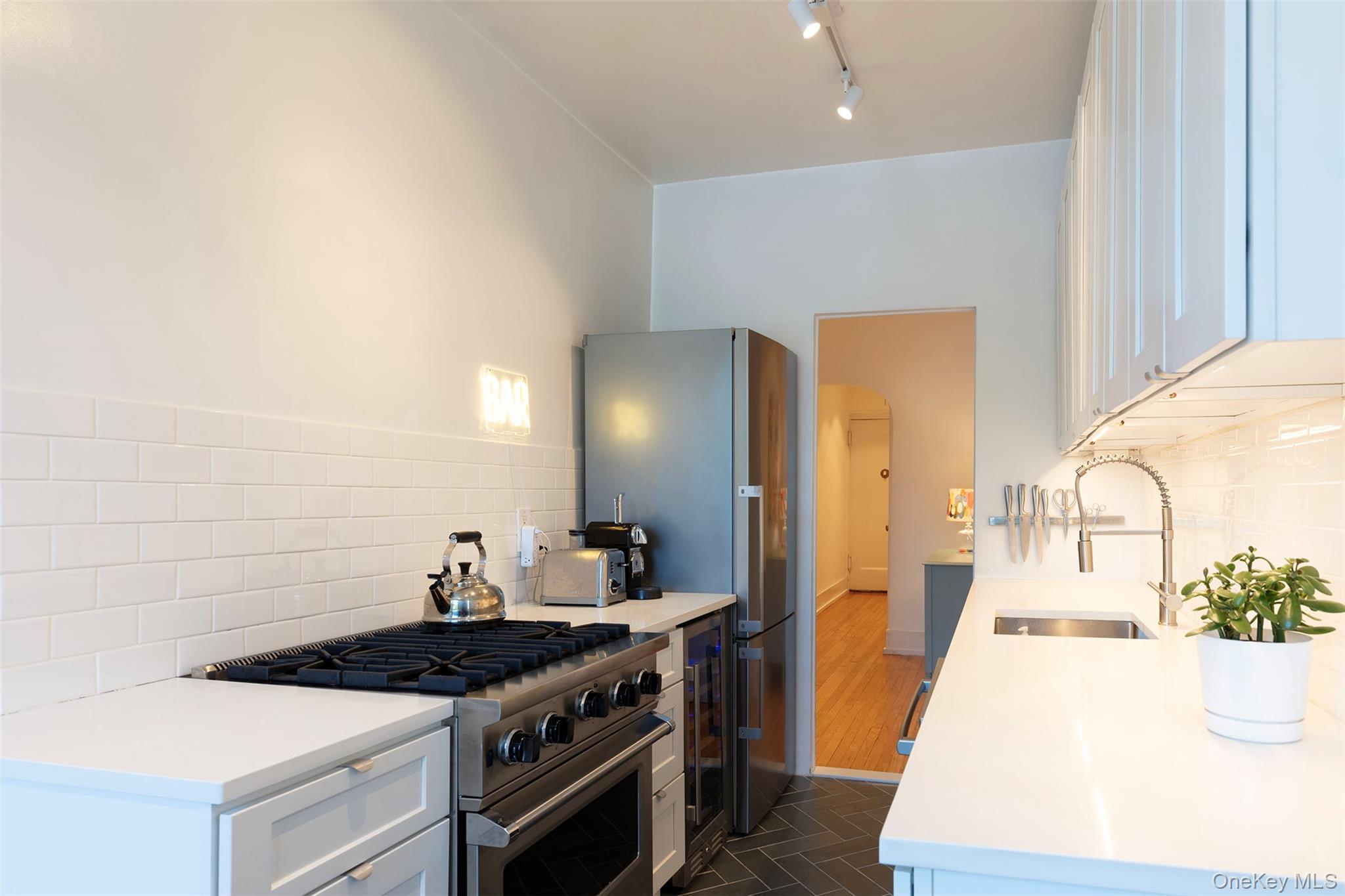 76-66 Austin Street, Unit 3L Queens, NY 11375 - Photo 6 of 28 a kitchen with a stove and a sink