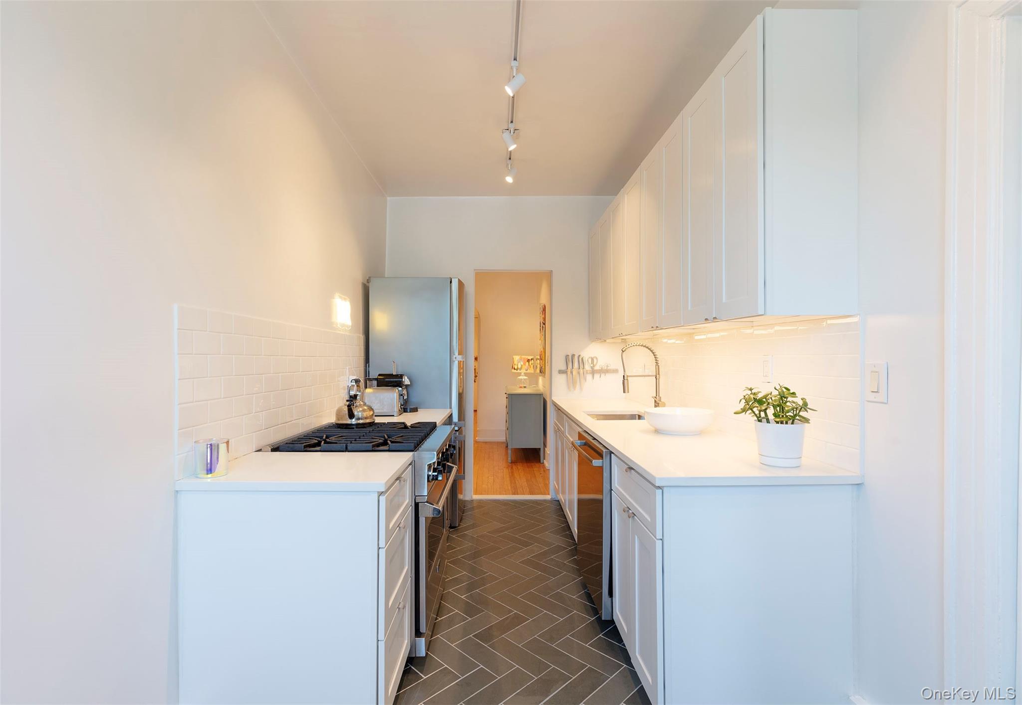 76-66 Austin Street, Unit 3L Queens, NY 11375 - Photo 7 of 28 a kitchen with a sink stove and cabinets