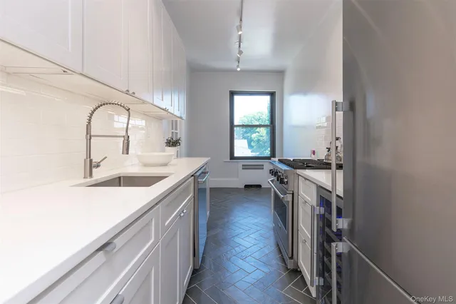 a kitchen with a sink stove and cabinets