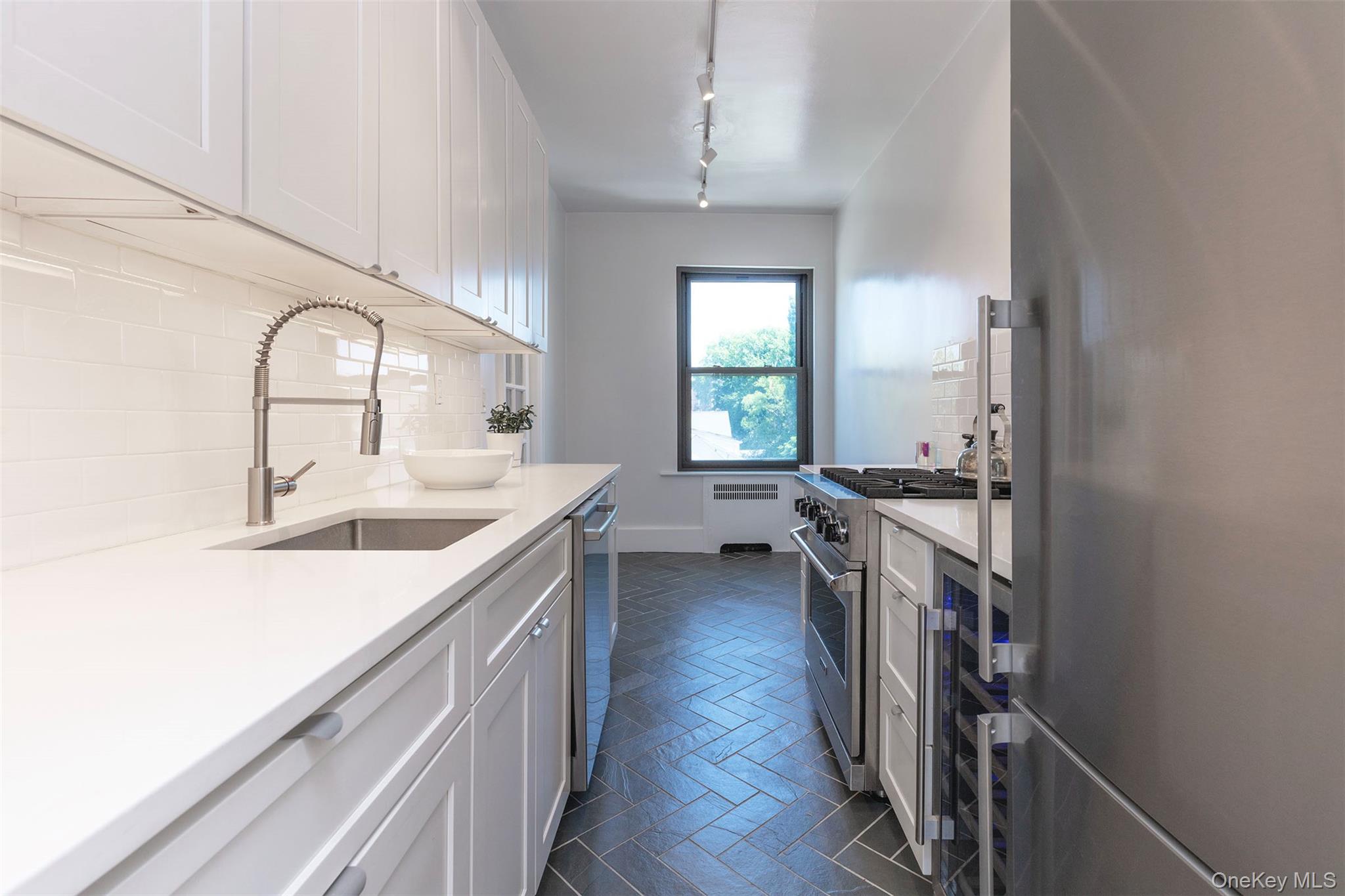 76-66 Austin Street, Unit 3L Queens, NY 11375 - Photo 8 of 28 a kitchen with a sink stove and cabinets