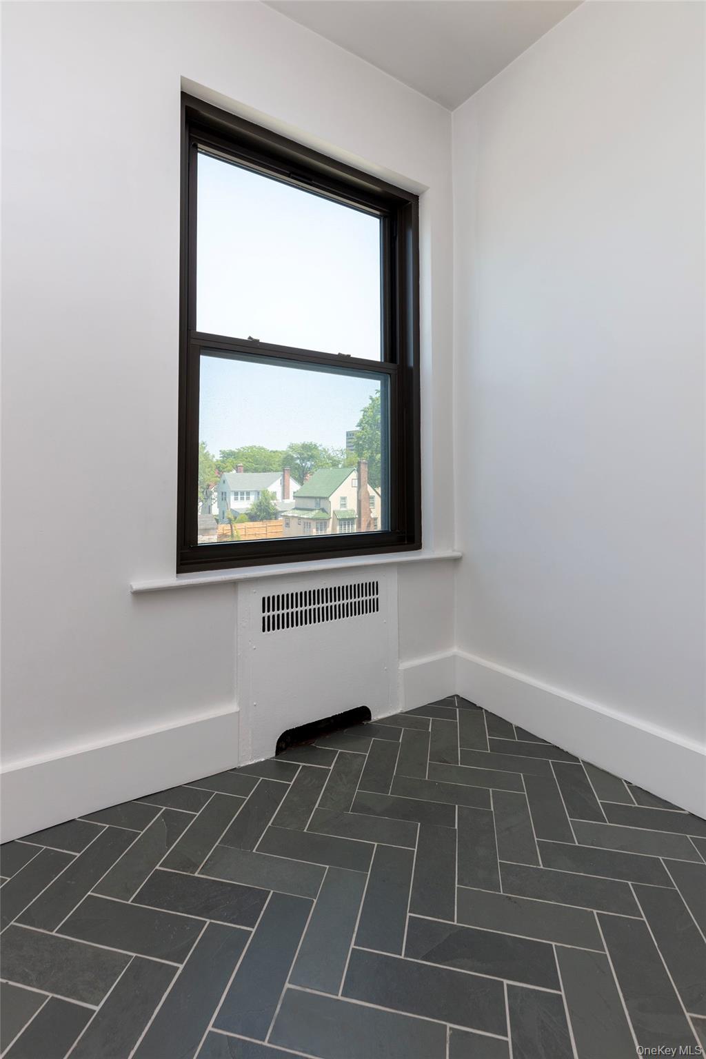 76-66 Austin Street, Unit 3L Queens, NY 11375 - Photo 10 of 28 view of an empty room with a window