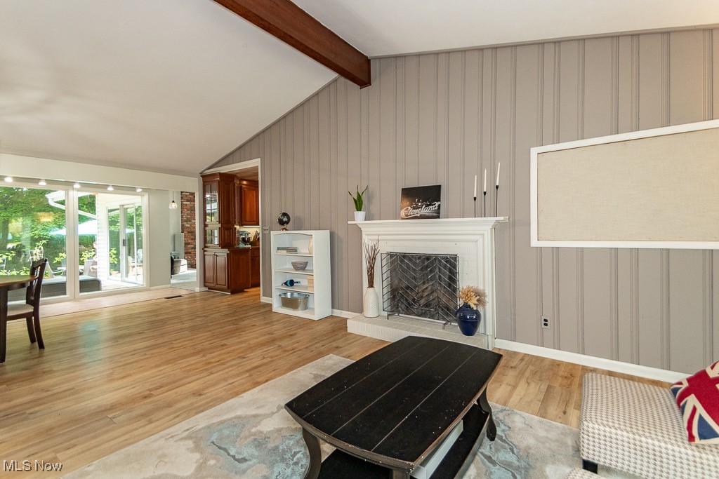 33 Woodside Road Chagrin Falls, OH 44022 - Photo 7 of 48 Living area featuring light wood-style flooring and a fireplace with raised hearth